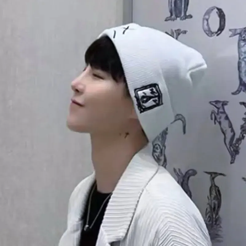 Embroidered Knitted Hat With Sad Expression